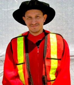 A graduating member wearing gear from the strike days.