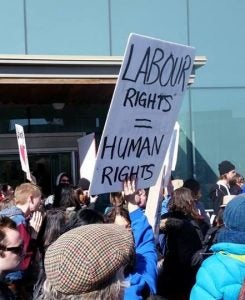 A sign reads "labour rights = human rights"